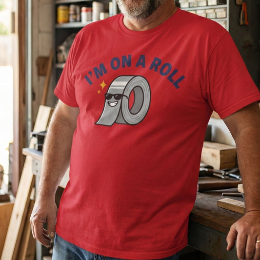 Person wearing a red t-shirt with a graphic design in a workshop setting