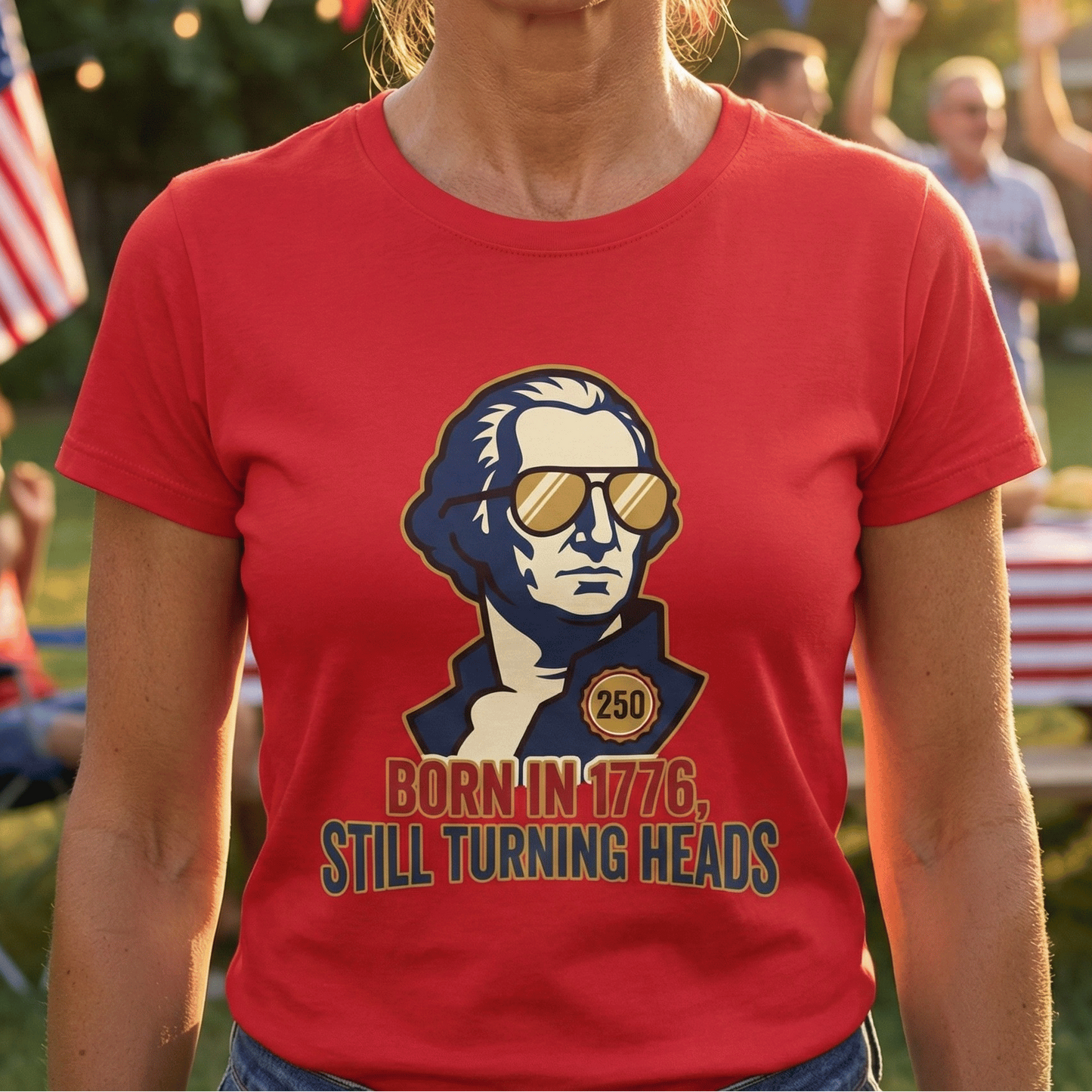 Woman wearing a red t-shirt with a graphic of a historical figure and text, standing outdoors with people and flags in the background.