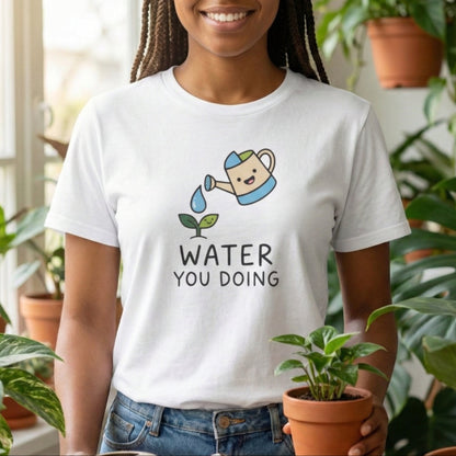 Person wearing a white t-shirt with a graphic and text, holding a potted plant in a room with plants.