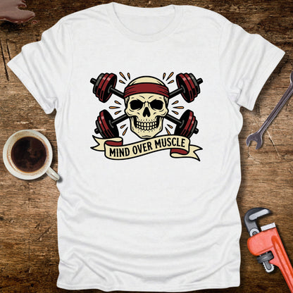 White t-shirt with skull and barbell design on a wooden surface with coffee and tools.