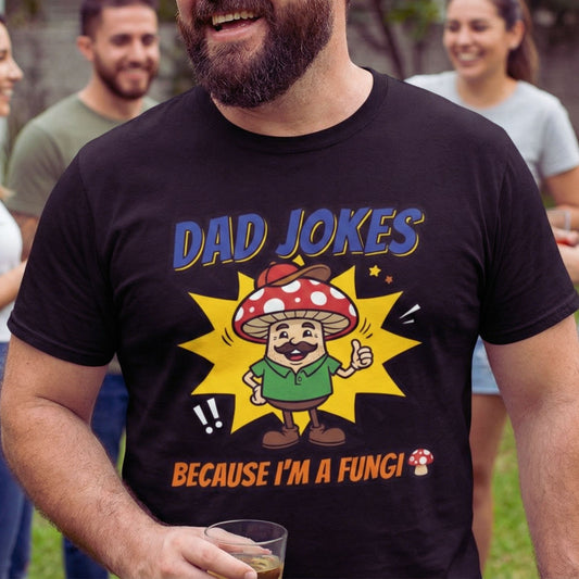 Man wearing a black t-shirt with a mushroom graphic and text, standing outdoors with friends.