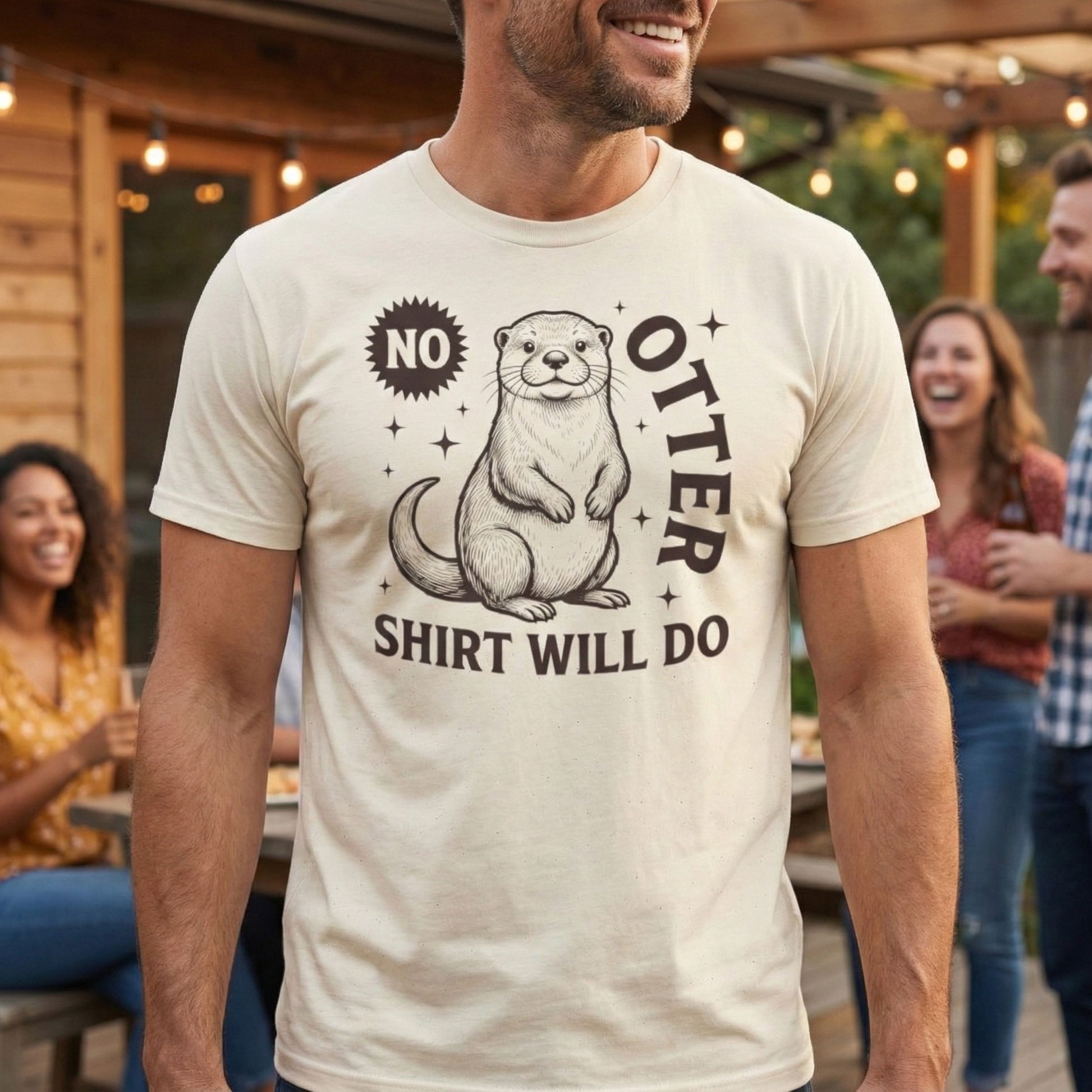 Man wearing a t-shirt with an otter graphic and text, standing outdoors with friends.