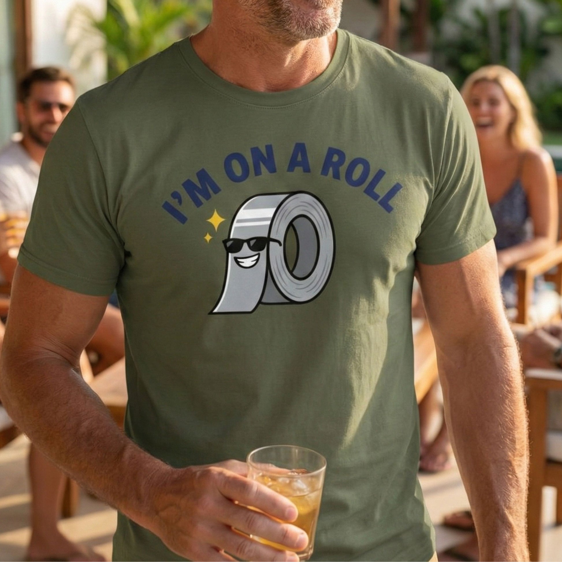 Man wearing a green t-shirt with a humorous graphic and text, holding a drink outdoors.