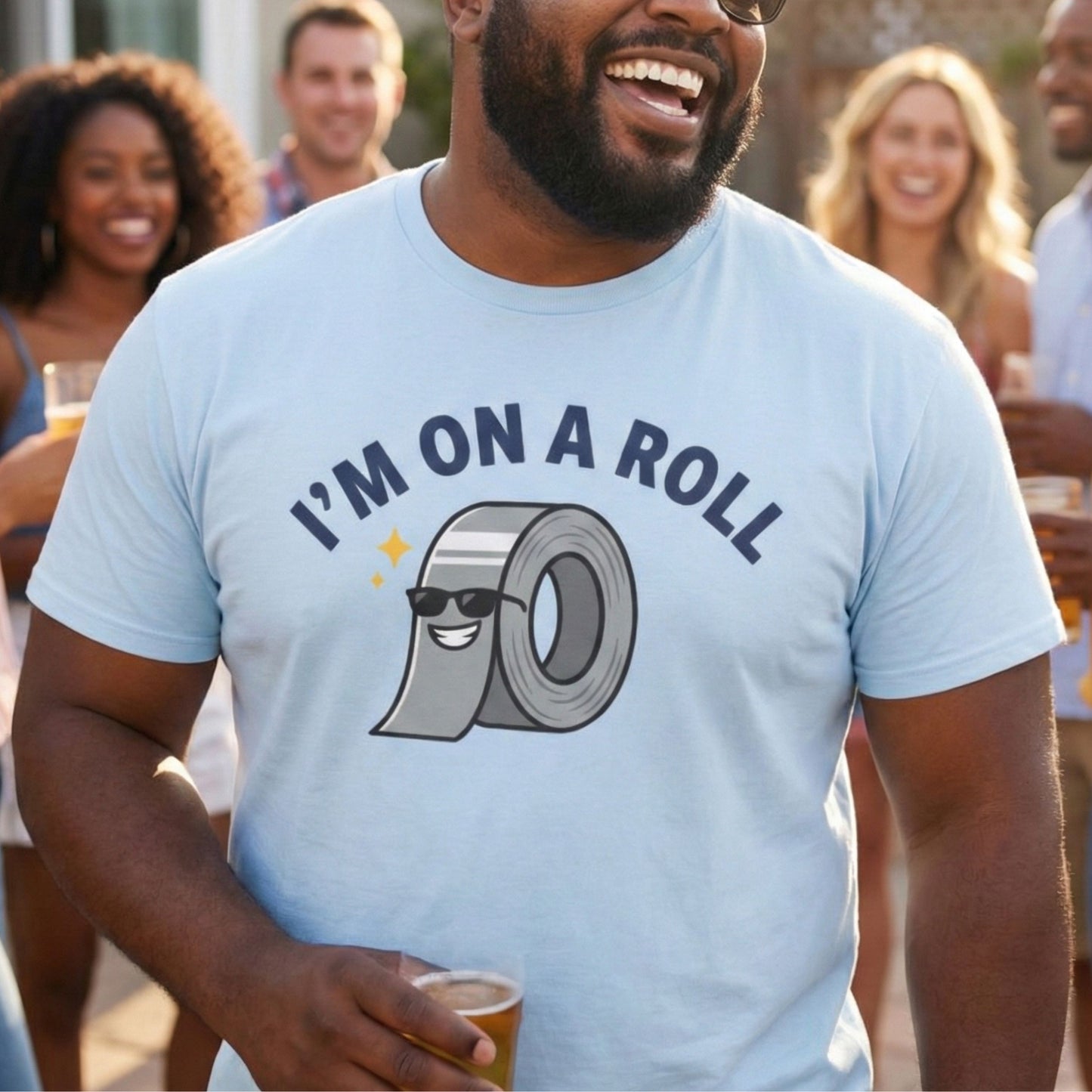 Man wearing a light blue t-shirt with 'I'm on a Roll' graphic and text, holding a drink, surrounded by people.