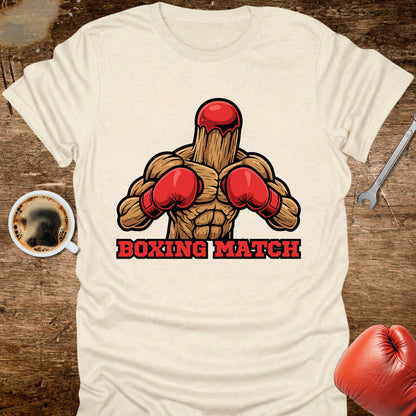 White t-shirt with boxing-themed graphic and 'Boxing Match' text on a wooden surface with coffee and gloves.