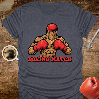 Gray t-shirt with boxing graphic and 'Boxing Match' text on a wooden surface with coffee and gloves.