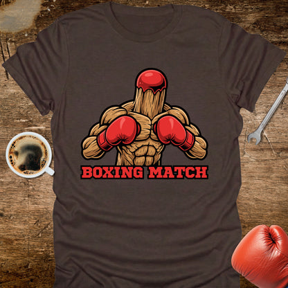 T-shirt with boxing glove graphic and 'Boxing Match' text on a wooden surface with coffee and gloves.