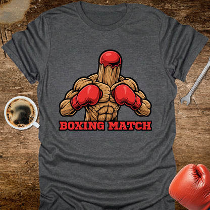 Gray t-shirt with a boxing graphic and 'Boxing Match' text on a wooden surface with coffee and boxing gloves.