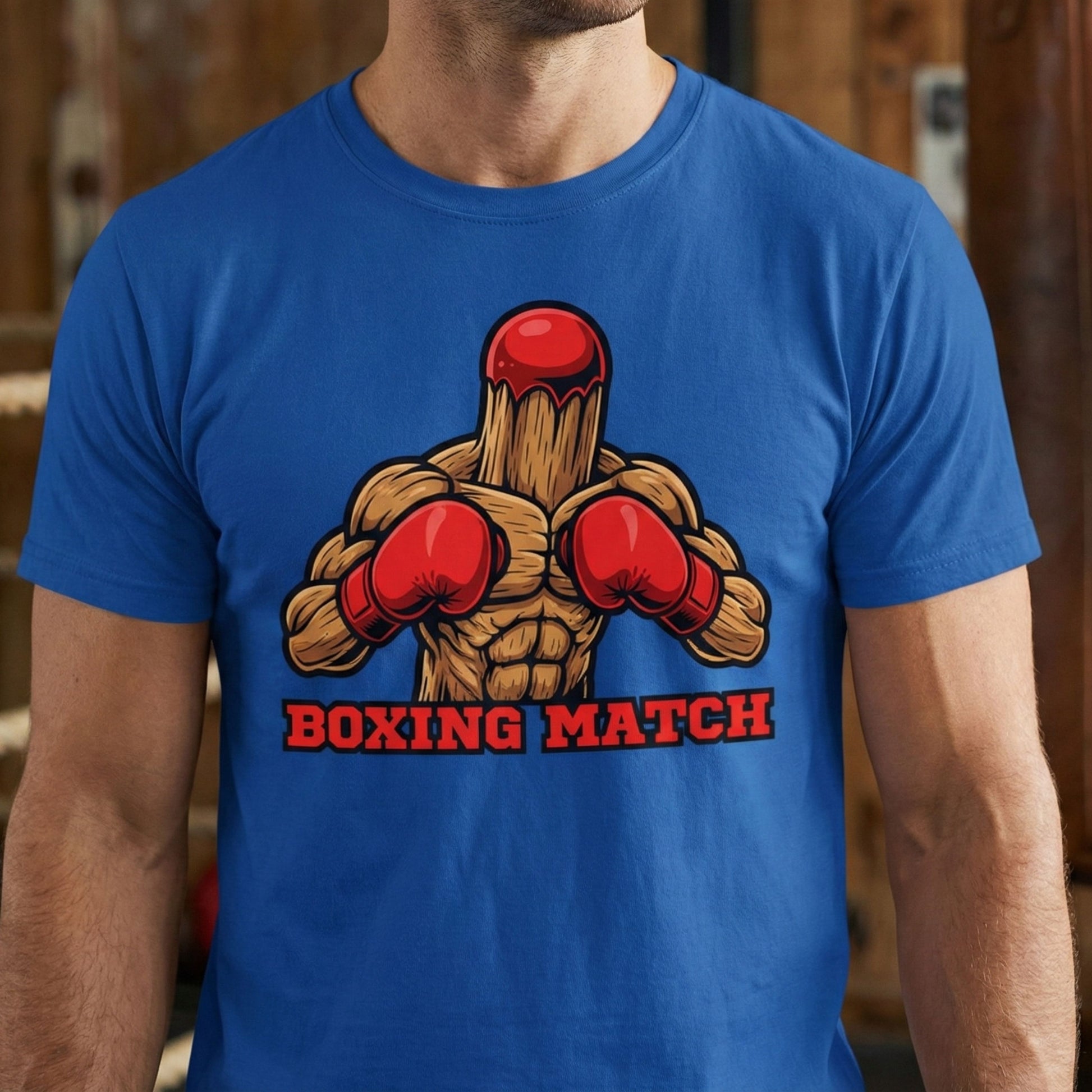 Blue t-shirt with a boxing-themed graphic and text 'Boxing Match' on a blurred background.