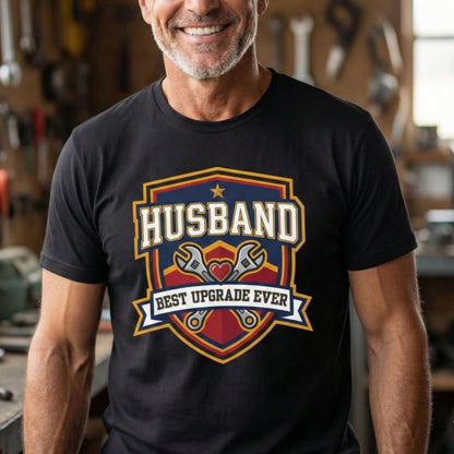 Man wearing a black t-shirt with 'Husband Best Upgrade Ever' graphic in a workshop.