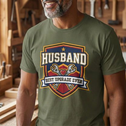 Man wearing a green t-shirt with 'Husband Best Upgrade Ever' graphic in a workshop.