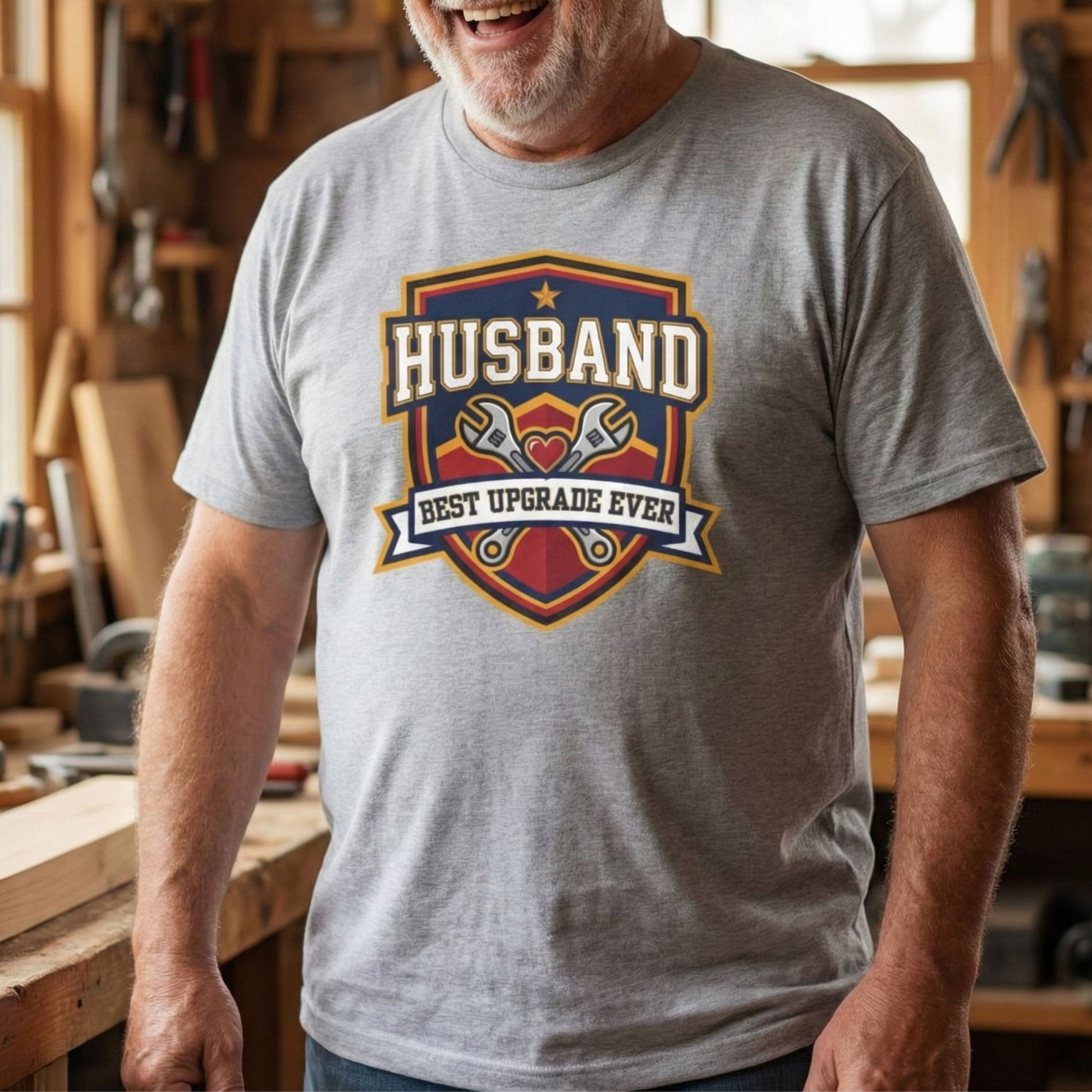 Man wearing a gray t-shirt with 'Husband Best Upgrade Ever' graphic in a workshop.