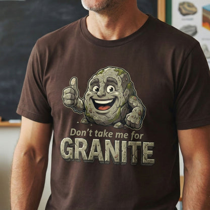 Person wearing a brown t-shirt with a cartoon character and text 'Don't take me for Granite' in front of a chalkboard.