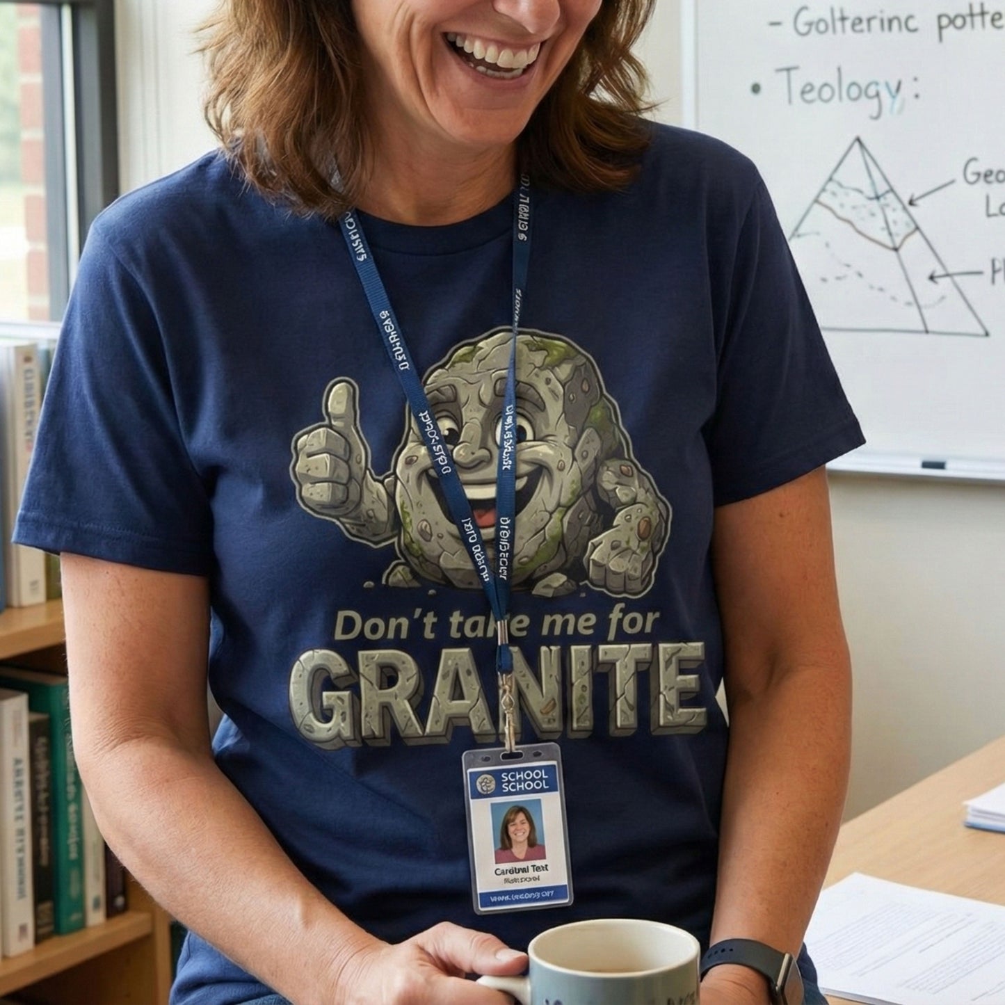 Person wearing a blue t-shirt with a graphic design and text, holding a mug in a classroom setting.