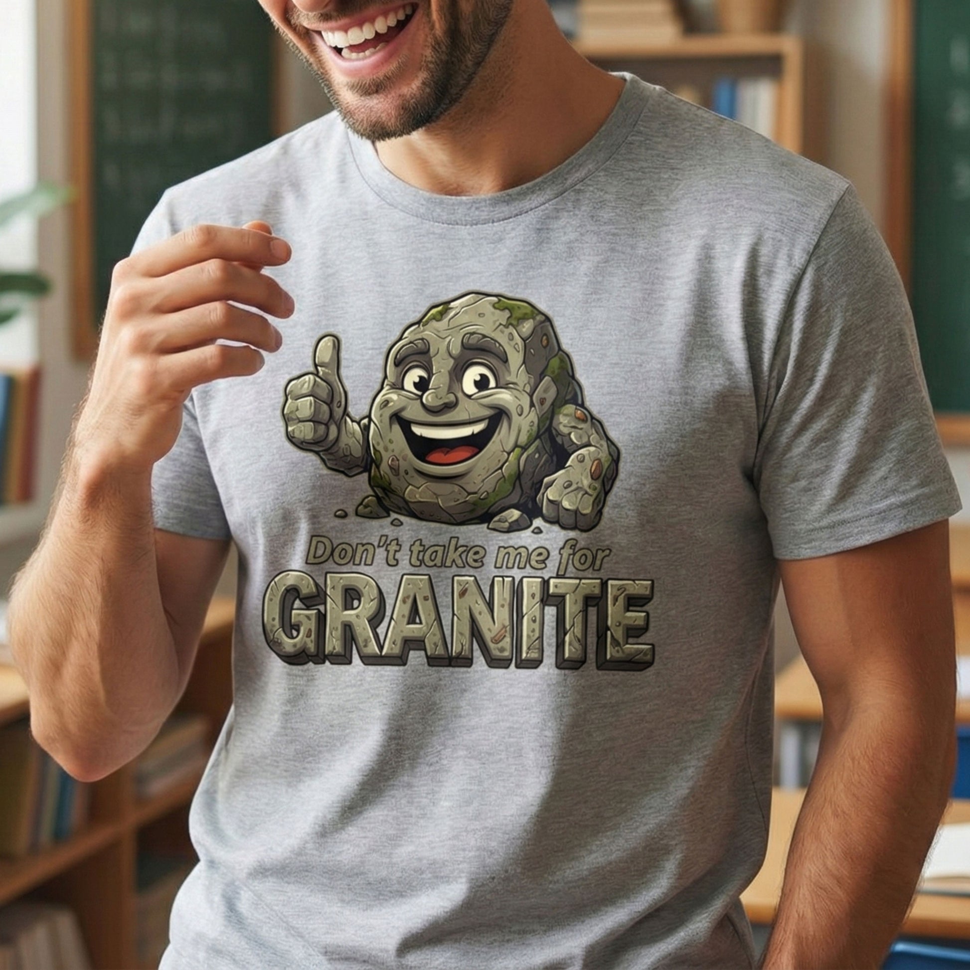 Person wearing a gray t-shirt with a cartoon rock character and text in an indoor setting.