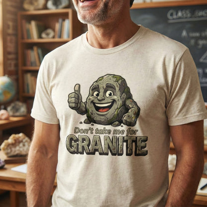 Man wearing a t-shirt with a cartoon character and text 'Don't take me for Granite' in a classroom setting.