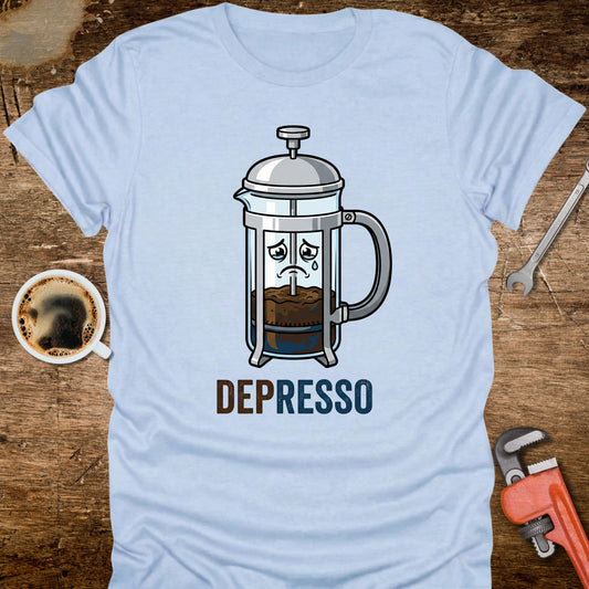 Light blue t-shirt with a coffee-themed graphic and 'DEPRESSO' text on a wooden surface.