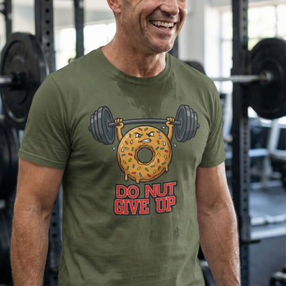 Man wearing a green t-shirt with a donut and barbell graphic and 'Do Not Give Up' text in a gym.